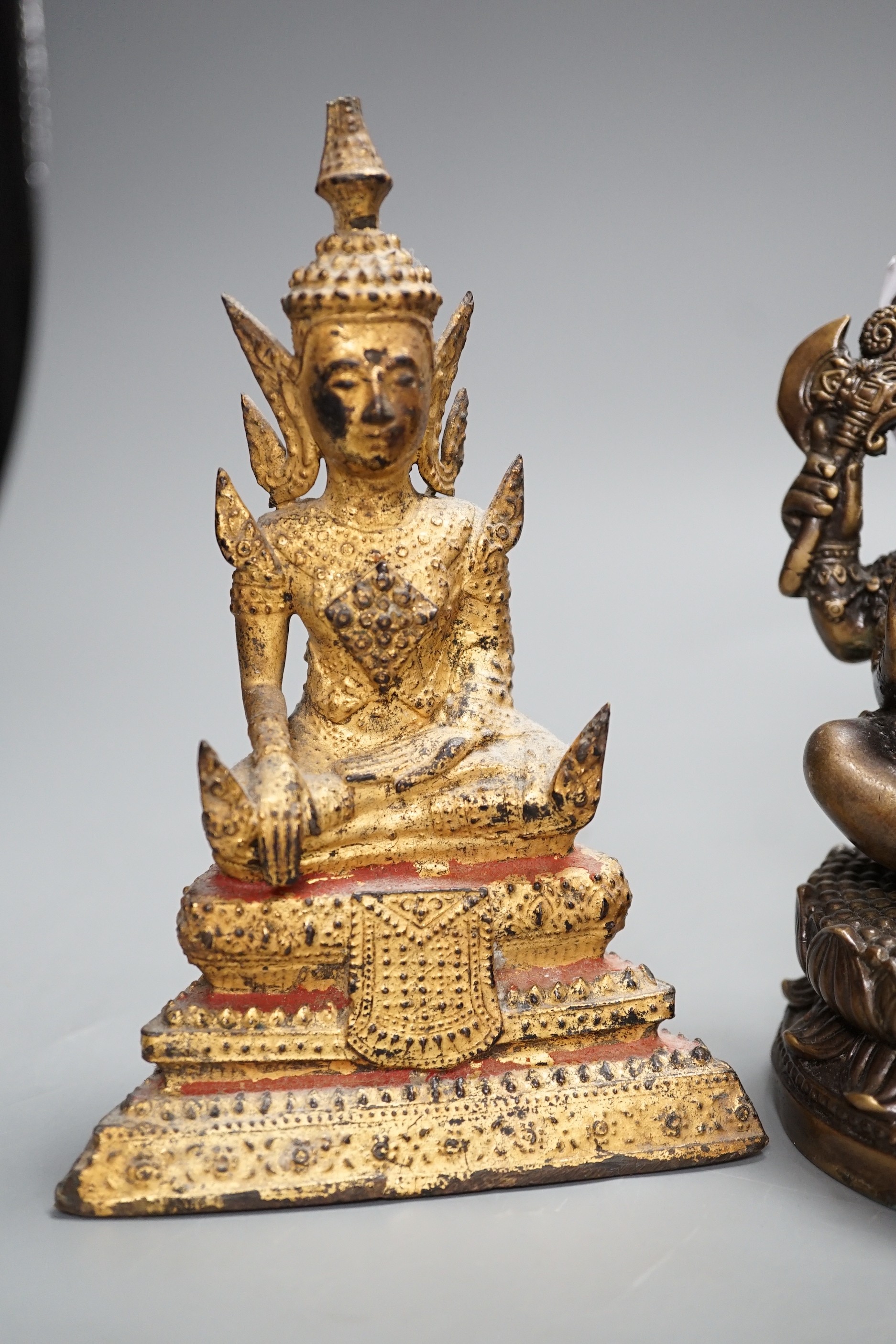 A Thai gilt resin model of Buddha, an Indian bronze model of Ganesh, a jadeite coloured carving of Guanyin and two other figures. Tallest 30cm